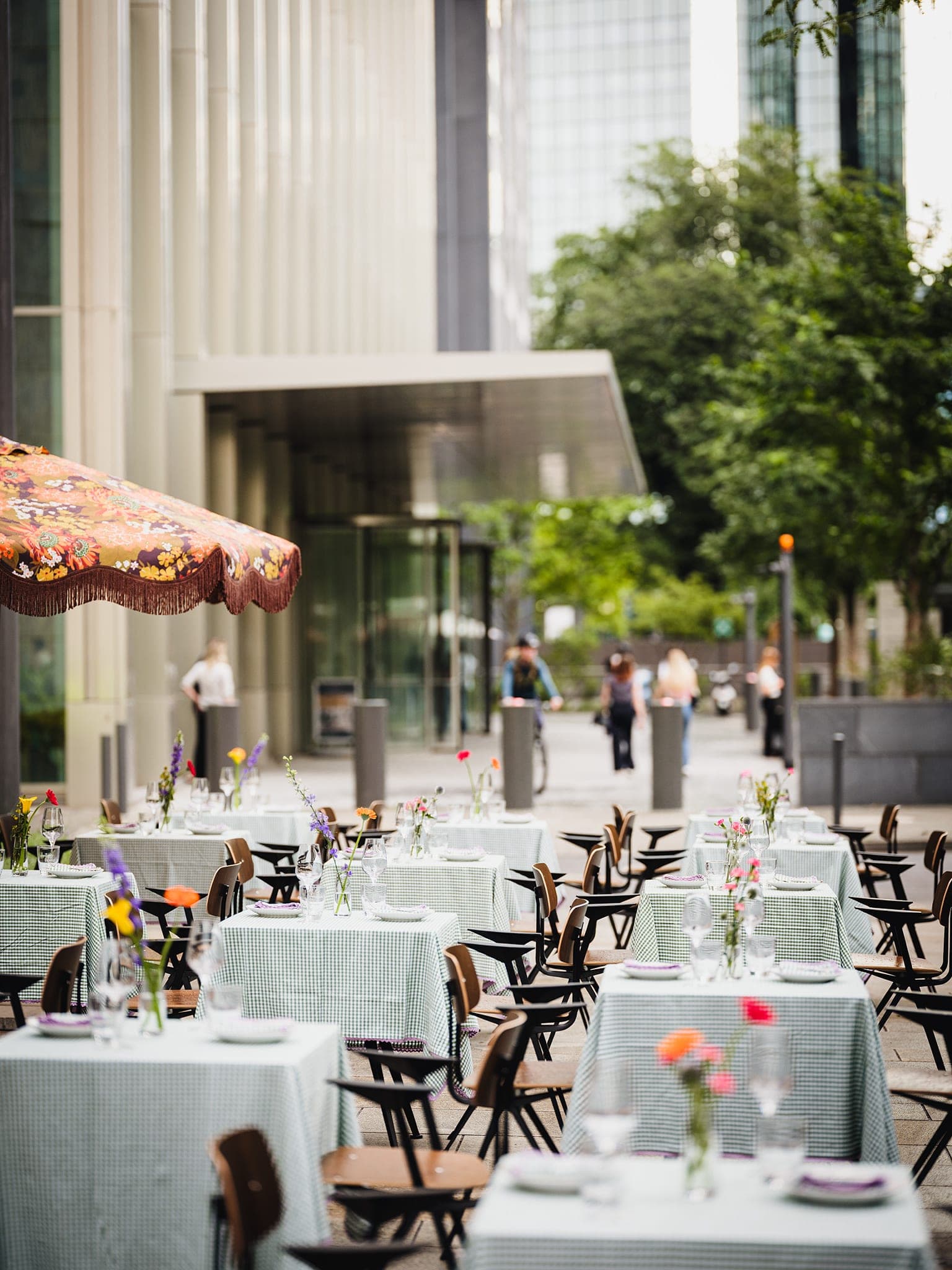 Rows of set tables on the terrace, the path beyond